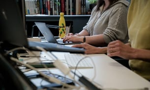People work at desks in the TBIJ office