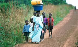 Villagers walk near Murchison Falls, Uganda